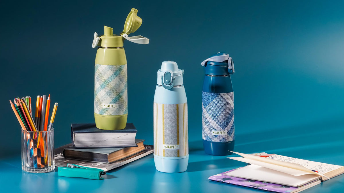 Jaypee school water bottles on a study desk