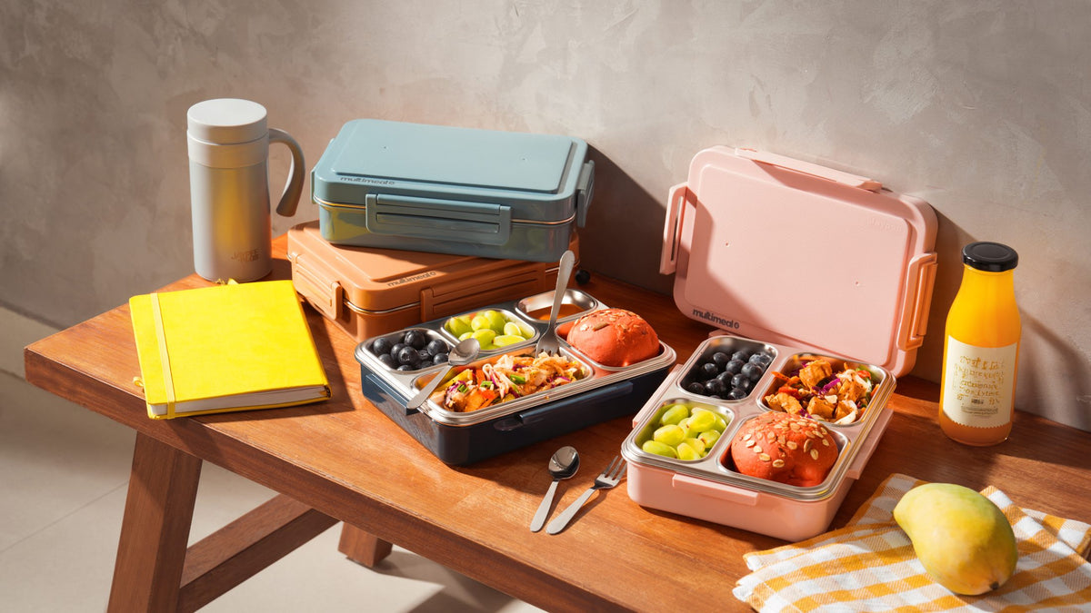 Jaypee lunch boxes laid out on a wooden table